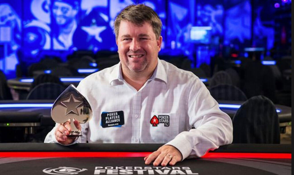 Chris Moneymaker, holding up poker World Championship trophy.
