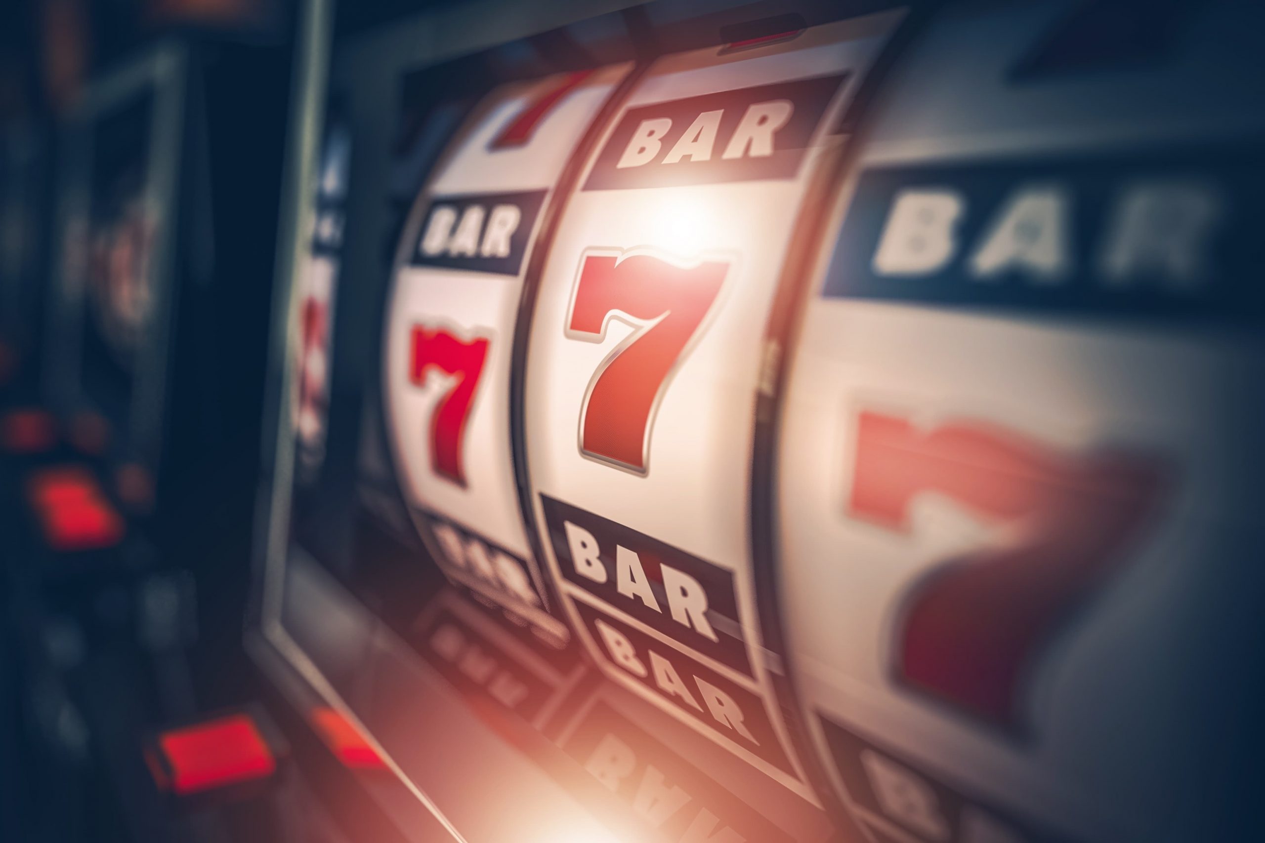 Slot machine showing three 7s.