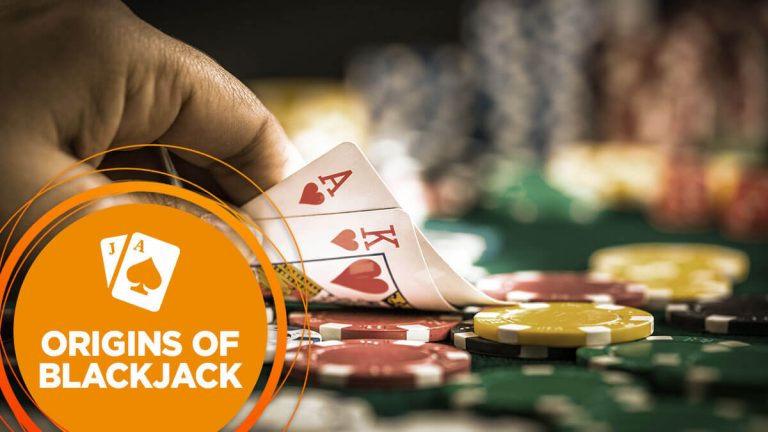 A player looks at blackjack cards to reveal ace and king of hearts..
