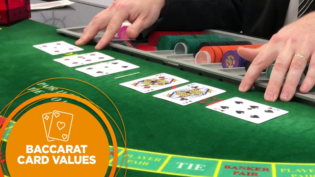 Dealer reveals banker and player cards at the baccarat table.