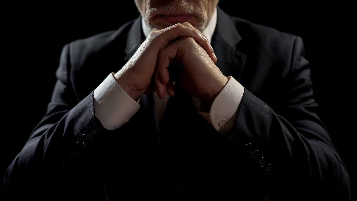 Billionaire businessman with arms folded.