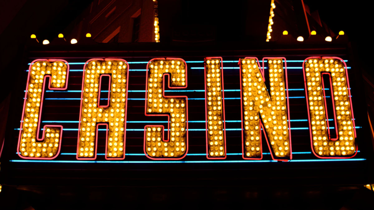 A neon Casino sign lit up to attract some famous gamblers