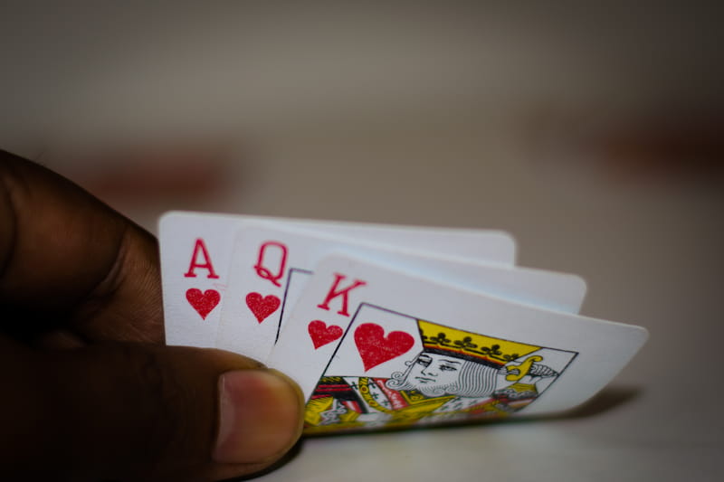 Three cards, slightly revealing the ace, king and queen of hearts. According to the Teen Patti rules, this is the second strongest hand possible!