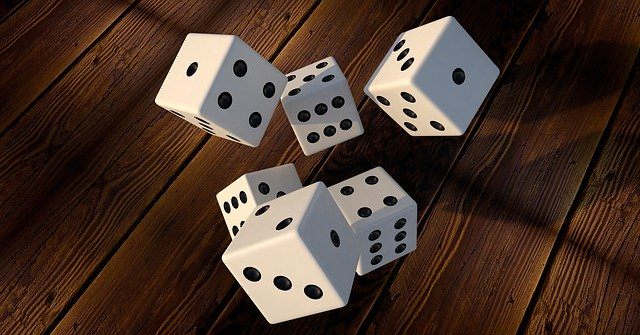 A set of six dice falling through the air.