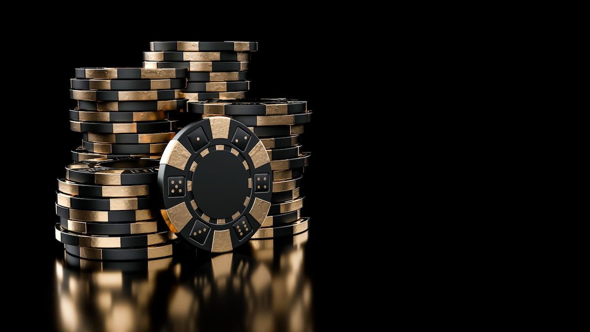 Stacks of black and gold casino chips