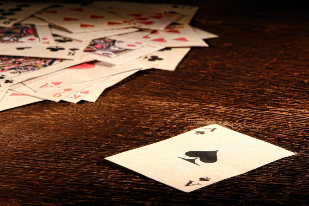 Old fashioned playing cards on a wooden table.