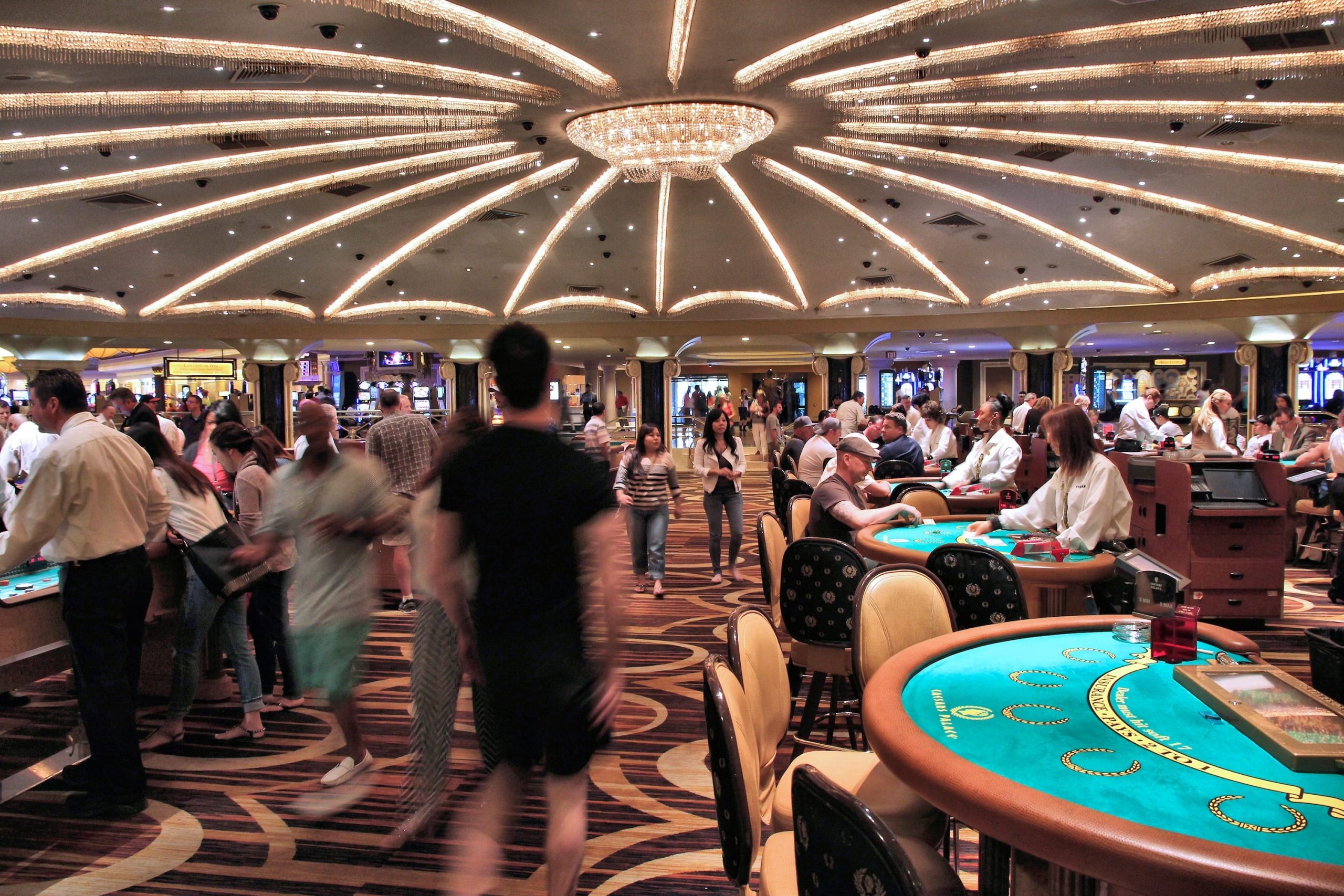 Players and croupiers on the floor of a casino.
