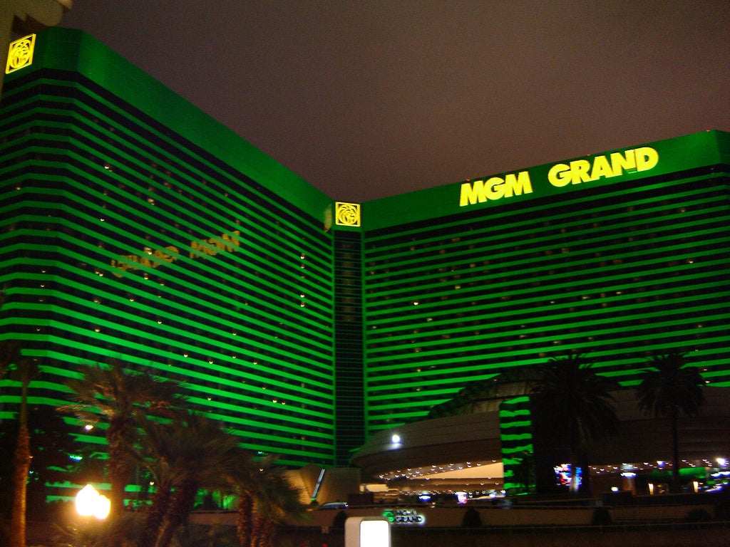 MGM Resorts Deal Doubts, Vegas Slowdown Rattle Casinos MGM Grand hotel and casino illuminated in green at night in Las Vegas