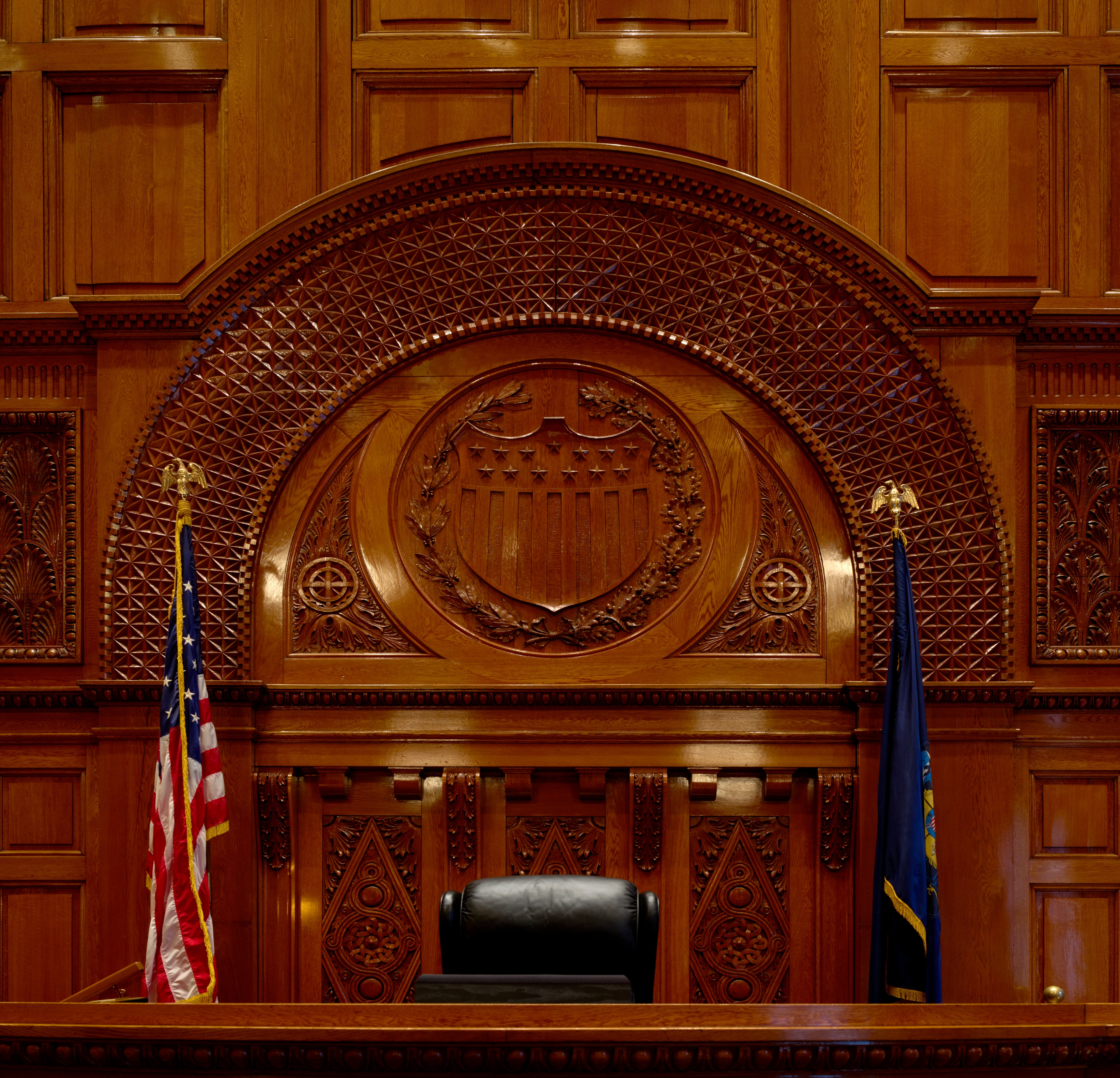 Tupac Shakur Murder Trial: Davis Convicted of Killing Empty judge's bench in a wood-paneled courtroom with an ornate carved seal, American flag, and state flag