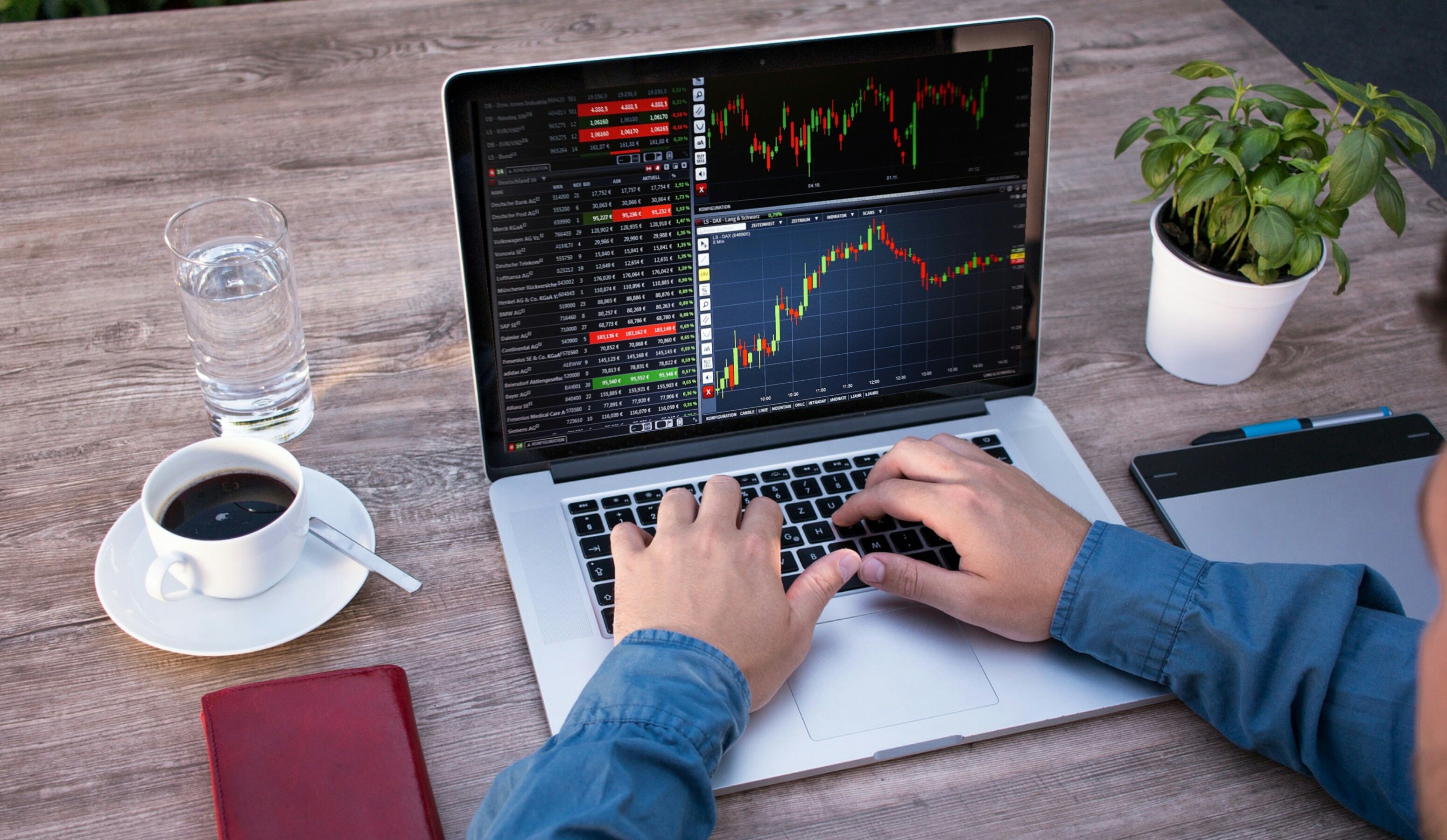 Nevada Slams Prediction Markets as NJ Goes to SCOTUS Person analyzing financial charts on a laptop at a wooden desk with coffee, notebook, stylus tablet, and plant, representing modern business analysis and trading workspace