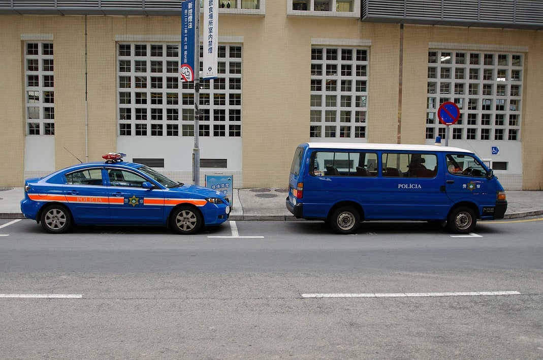 Macau police car parked along city street in 2012