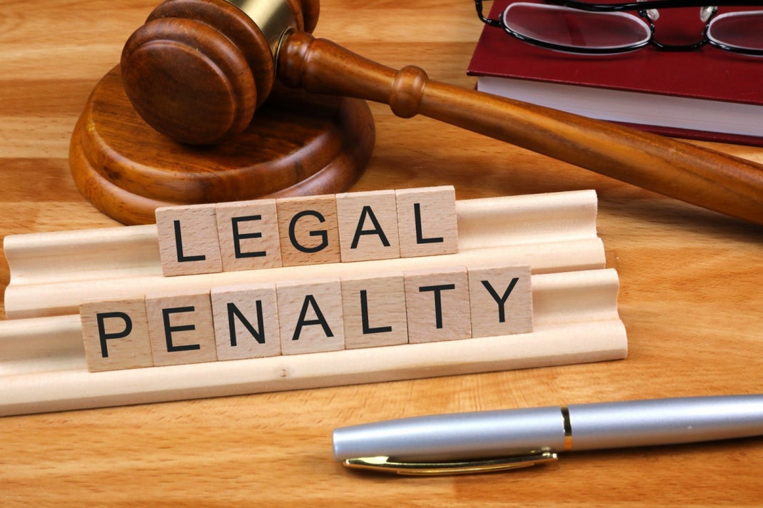Gavel and legal penalty tiles representing AGCO fines against Relax Gaming and Arrise Solutions in Ontario