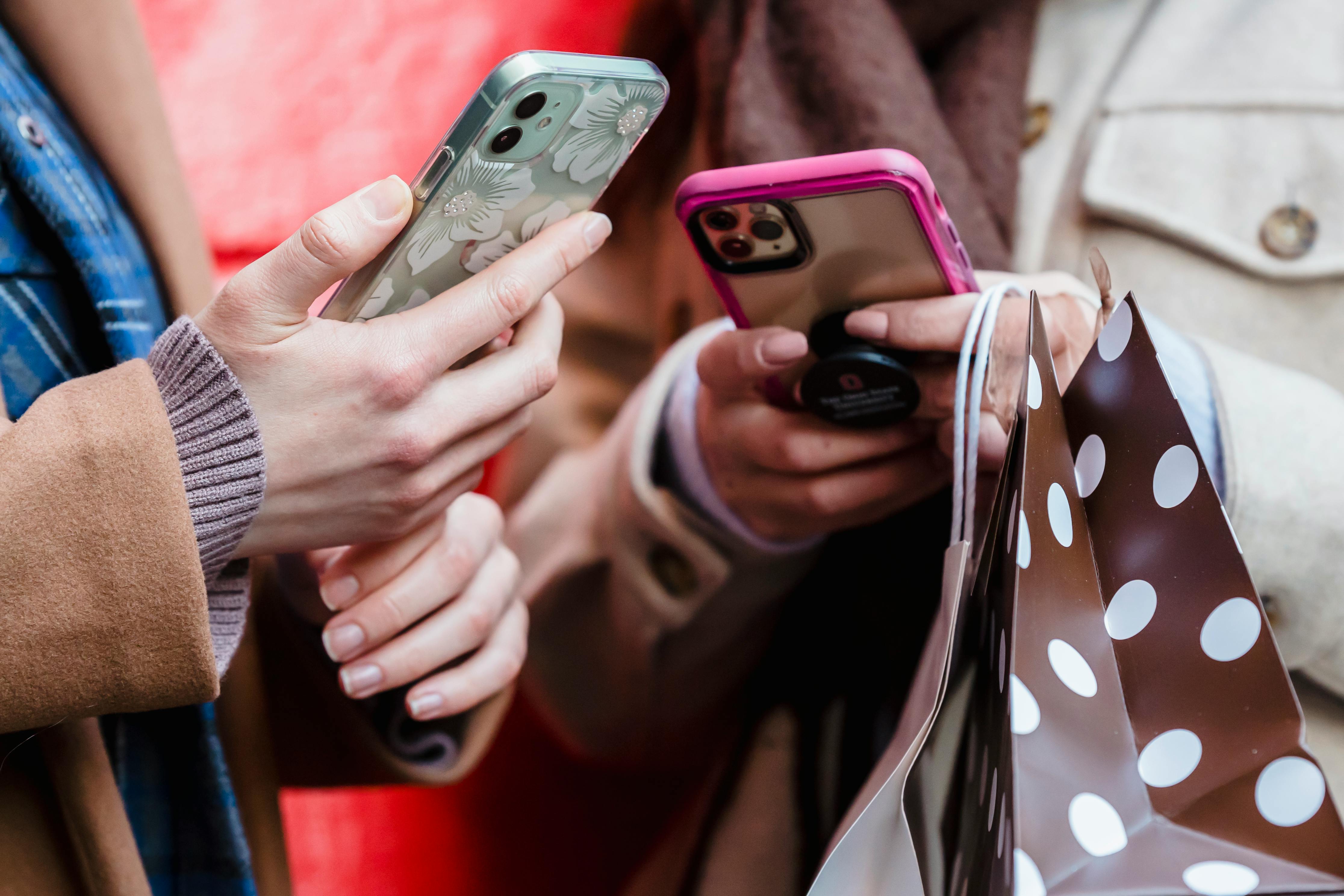 Unrecognizable ladies using smartphones on street - pexels.com People Using Their Phones
