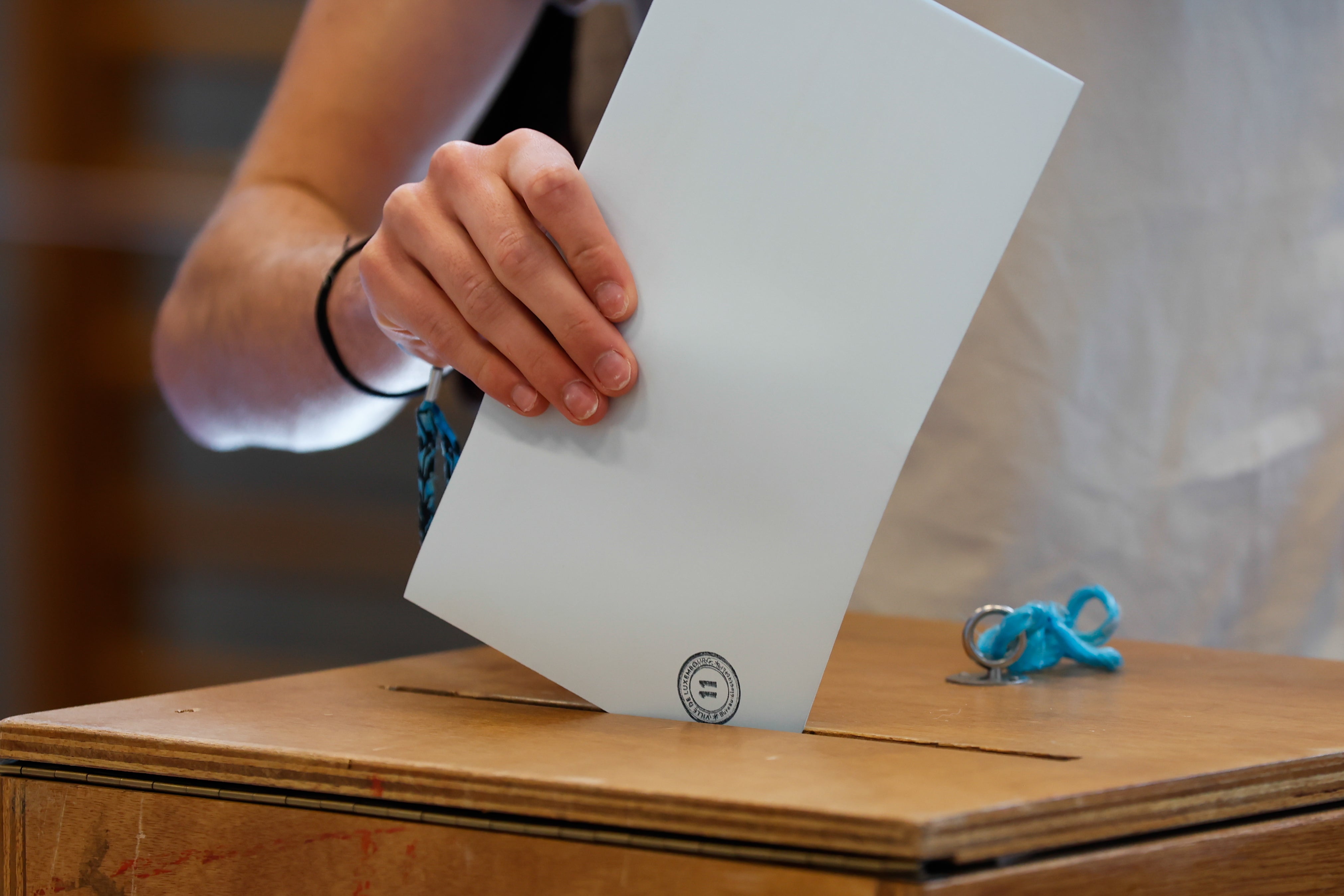 Quebec Online Gambling Could Be Legalized After Election Voter casting a ballot at a polling station, representing Quebec's Oct. 5 election