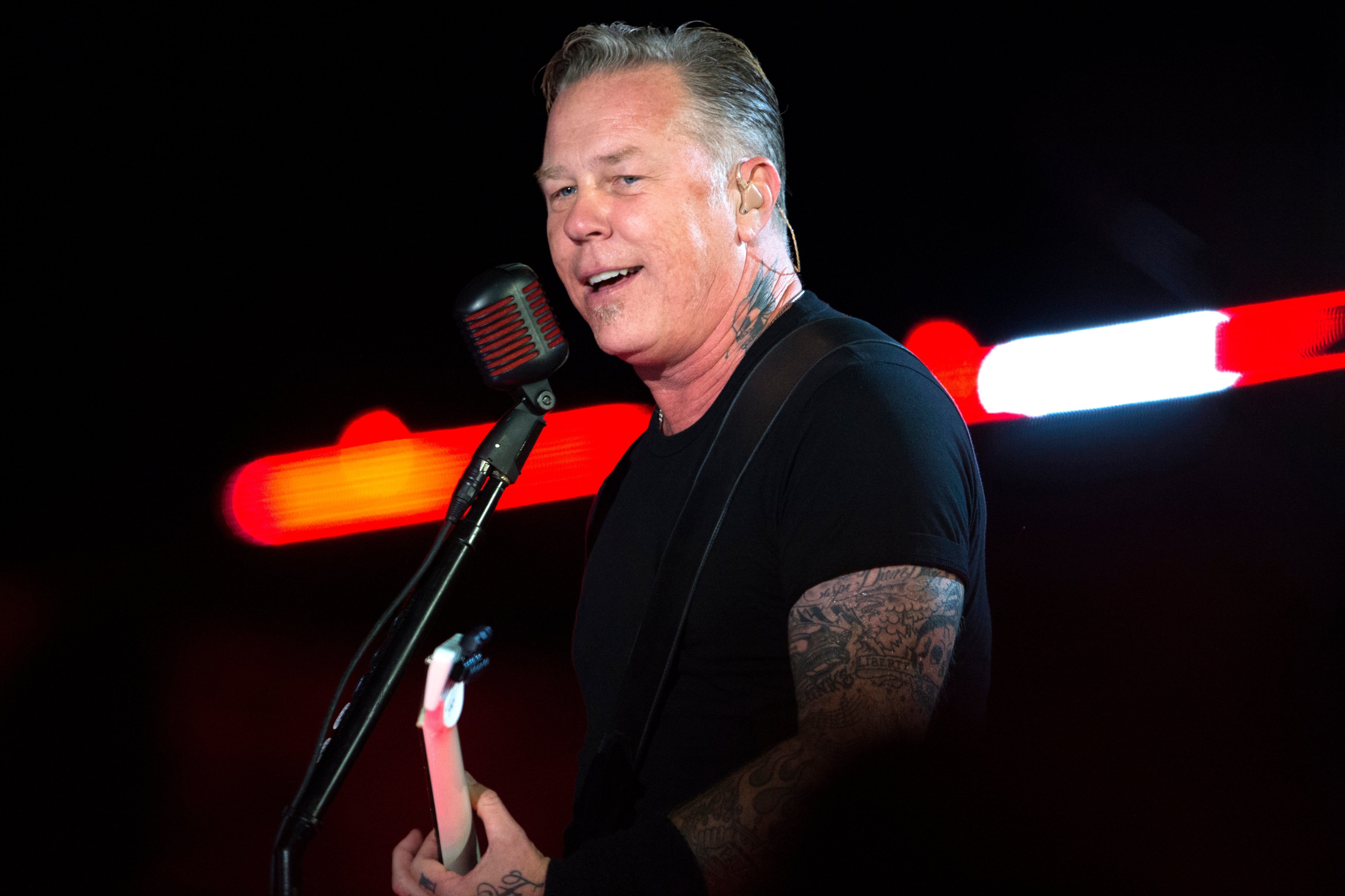 Metallica frontman James Hetfield singing and playing guitar on stage during a 2014 concert