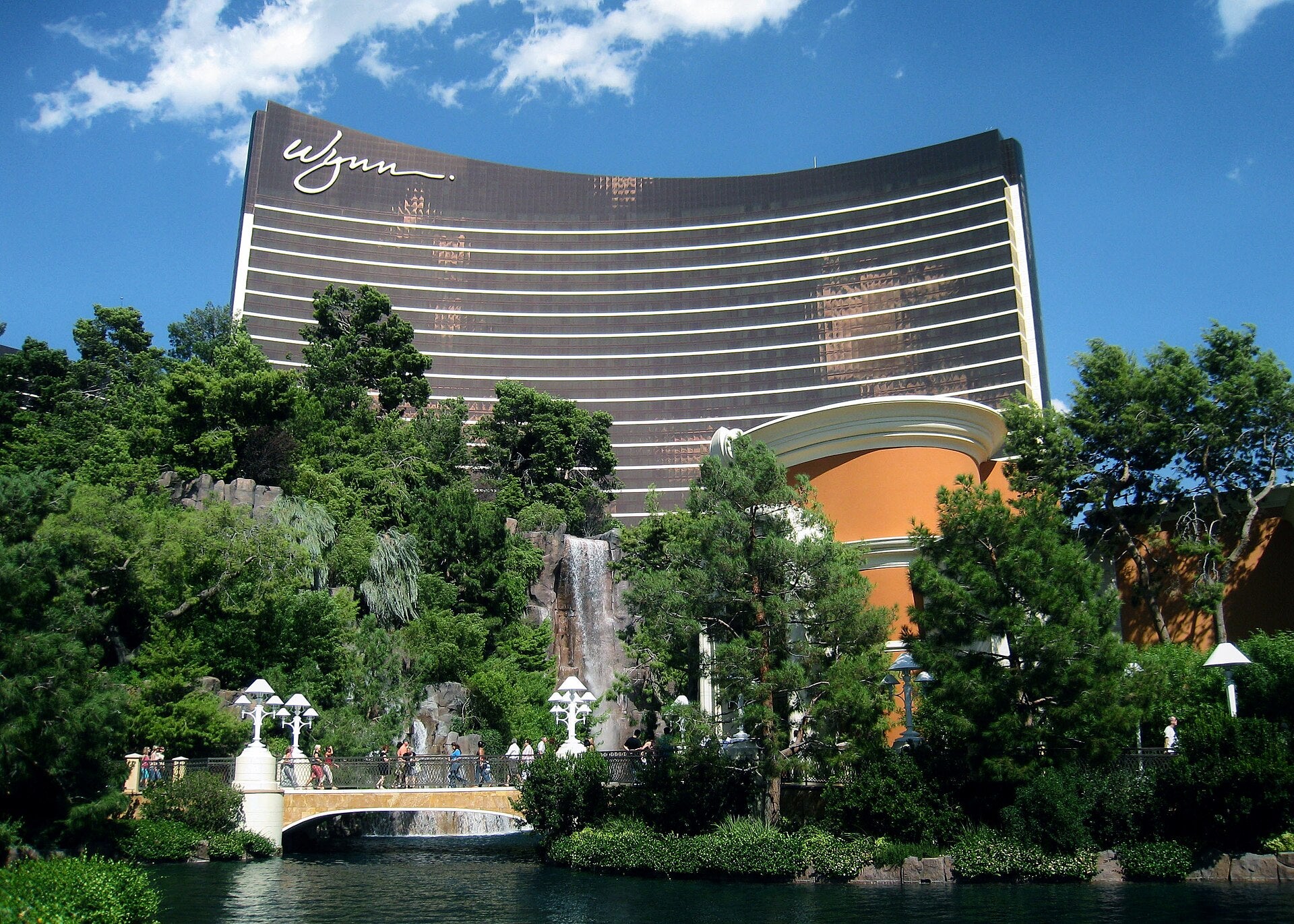 Exterior view of Wynn Las Vegas resort with waterfall and lagoon