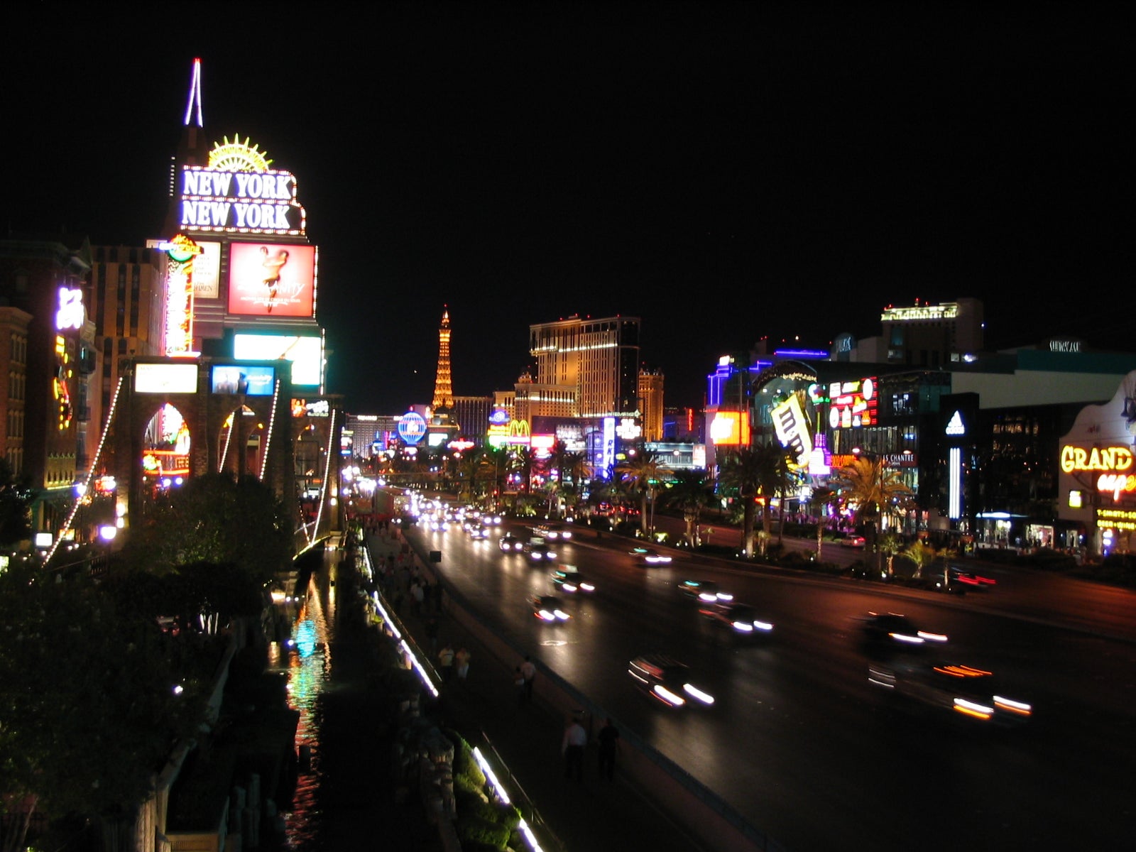 Las Vegas Strip at night with New York-New York casino and Paris hotel Eiffel Tower replica in the background