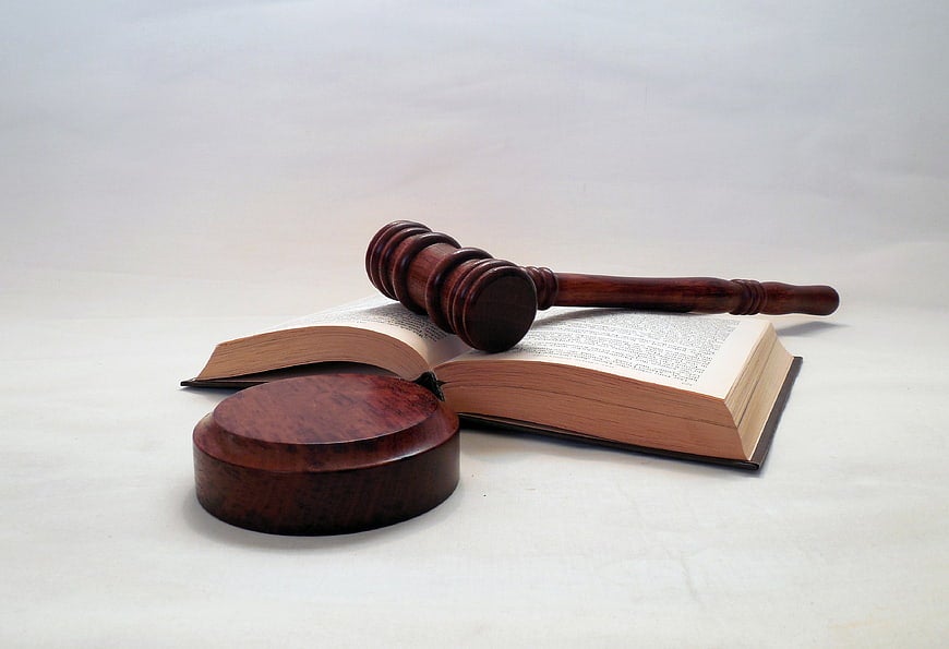 Vegas Matt Threatens Legal Action Against Rob ODAAT Wooden gavel and sound block resting on an open law book, representing the legal demand letter sent to Rob ODAAT
