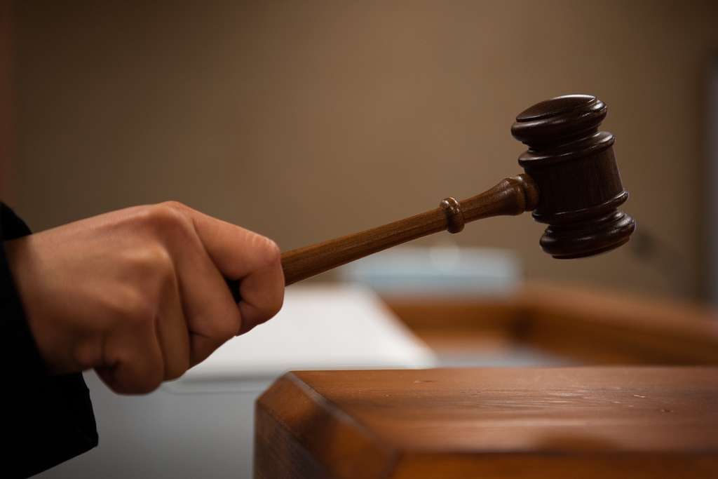 A Judge Hitting a Gavel in Court