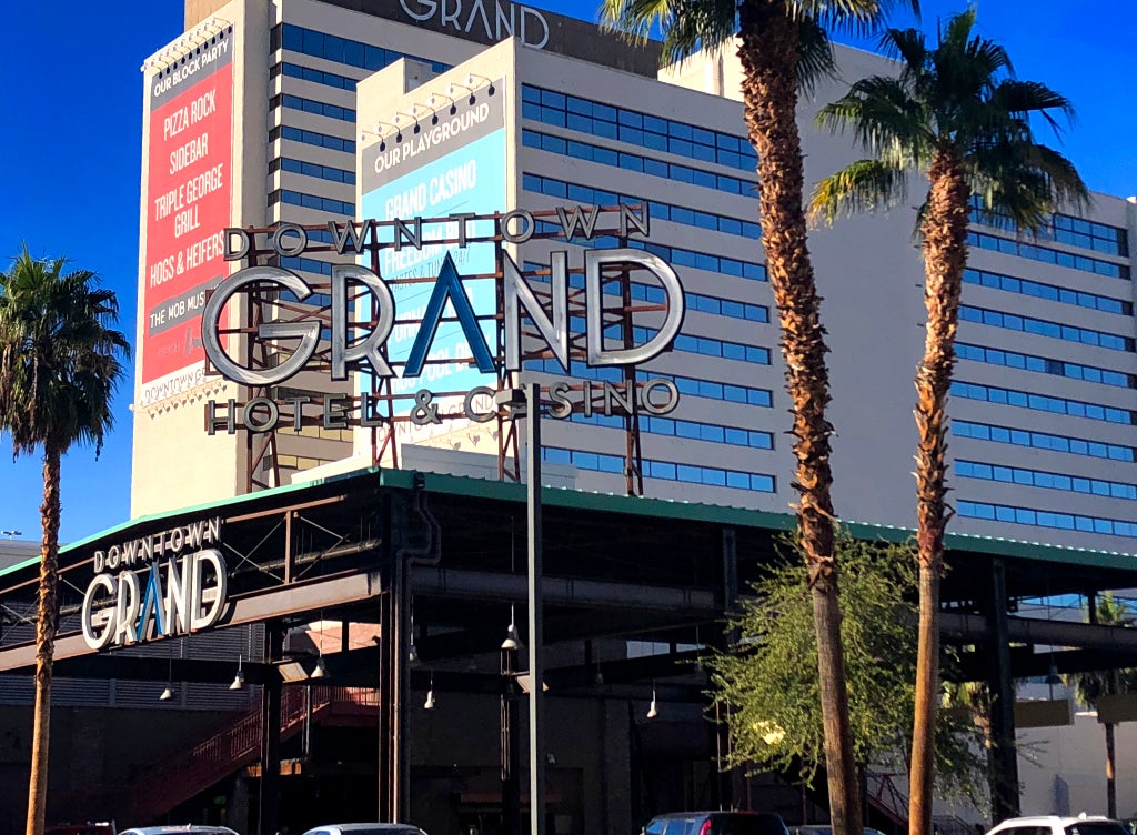 Downtown Grand Hotel and Casino Exterior in Downtown Las Vegas Exterior view of Downtown Grand Hotel and Casino with signage and palm trees in downtown Las Vegas