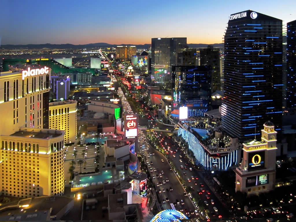 Aerial view of the Las Vegas Strip at dusk showing casino resorts along South Las Vegas Boulevard