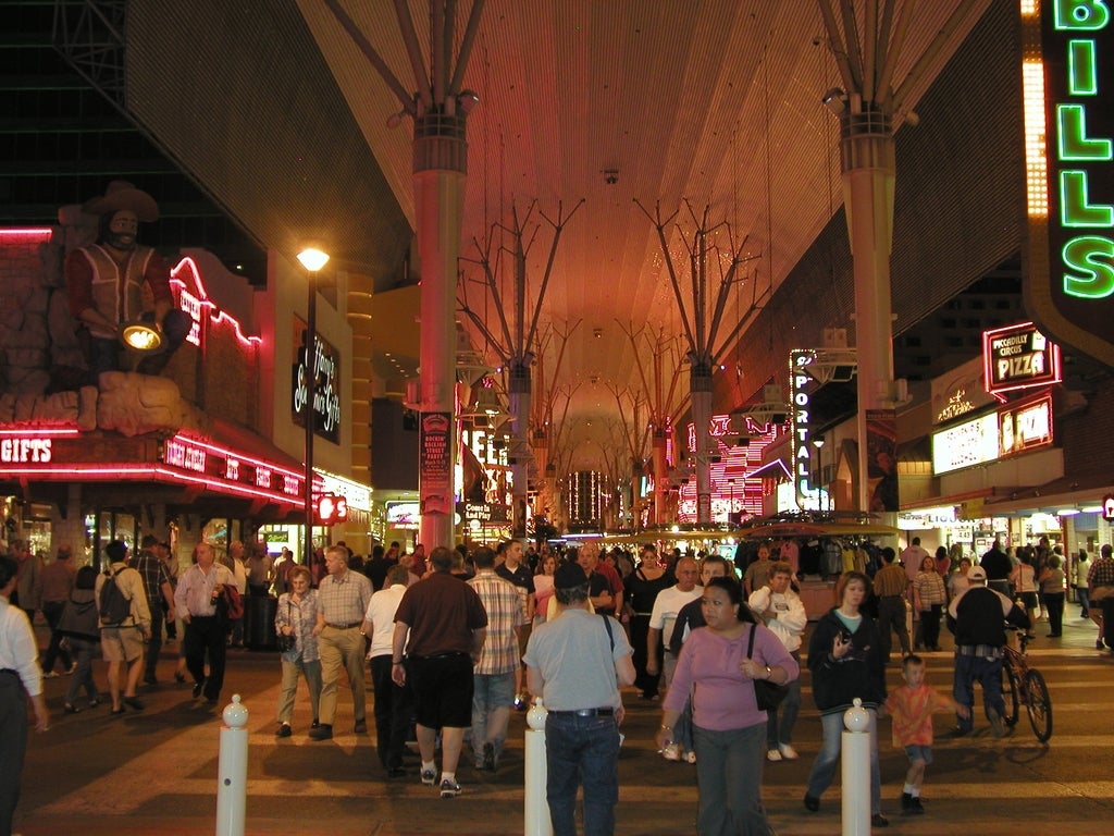 Las Vegas Visitation Rebounds in May After Slow Months Crowds of visitors walking along Fremont Street Experience in Las Vegas at night under the LED canopy