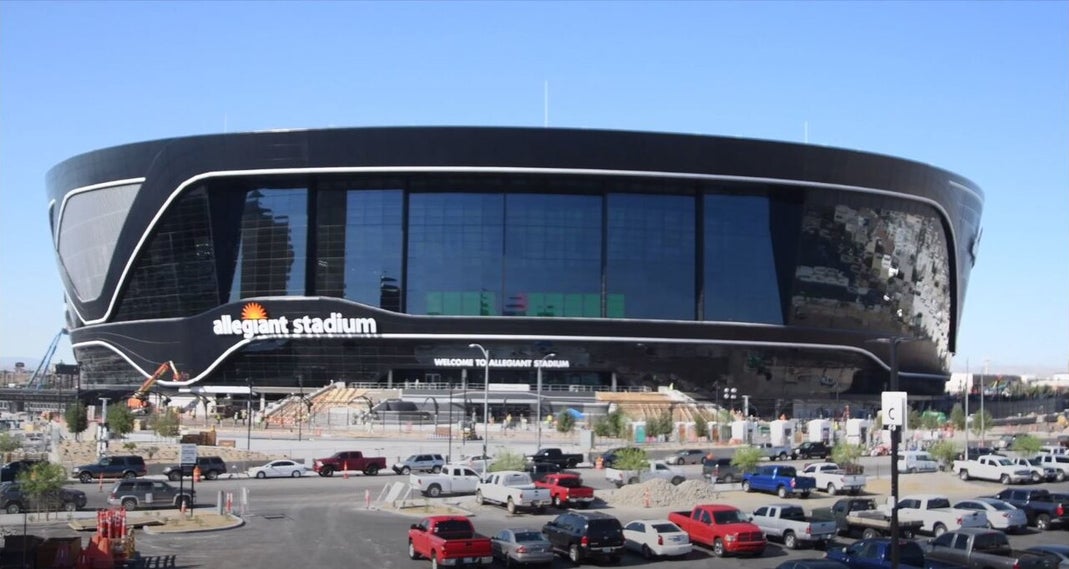 Exterior view of Allegiant Stadium in Las Vegas, Nevada, showing the modern black facade and surrounding area in June 2020