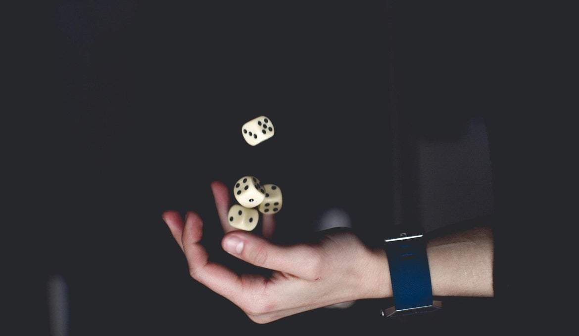 an image of someone with four dice juggling
