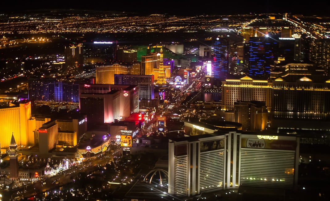 Aerial night view of the Las Vegas Strip with illuminated casino hotels and city lights