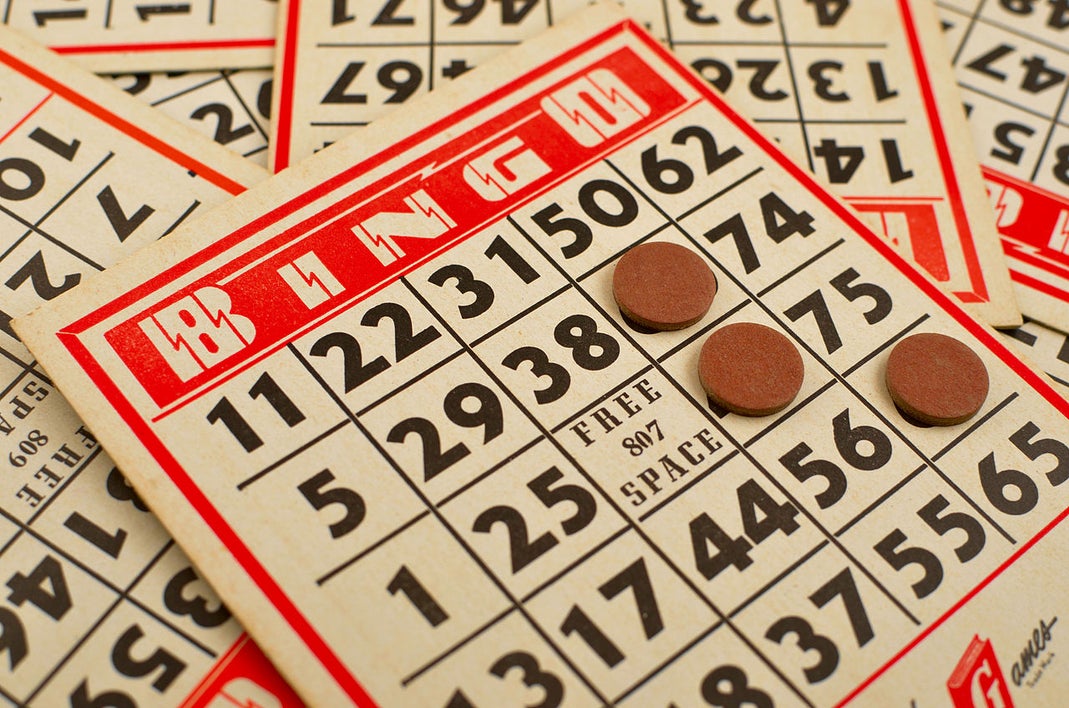 Close-up of traditional bingo cards with markers highlighting selected numbers during gameplay