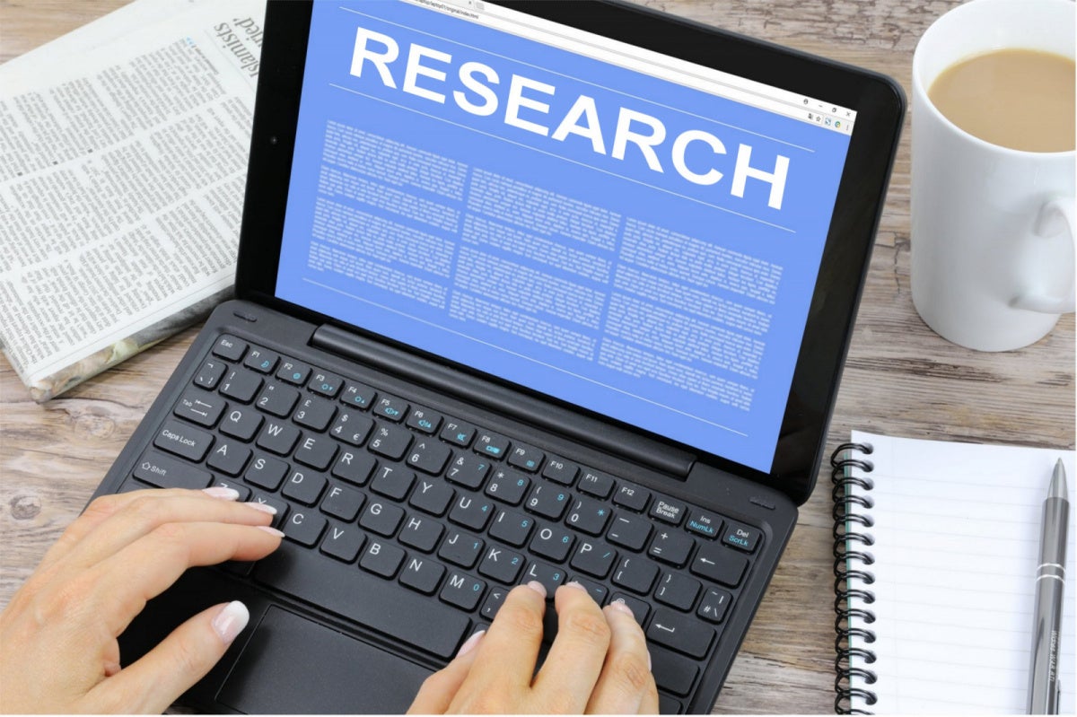 iGaming Ontario Problem Gambling Study Kept Under Wraps Person typing on a laptop displaying the word research, illustrating iGaming Ontario's problem gambling study