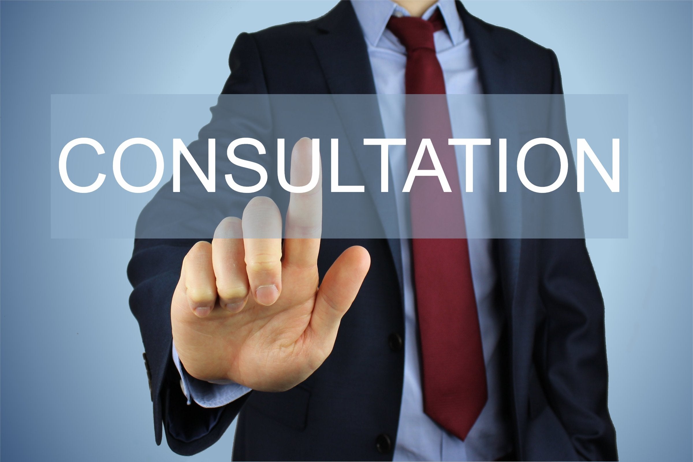 Image of the word 'consultation' with someone in a suit and tie touching it