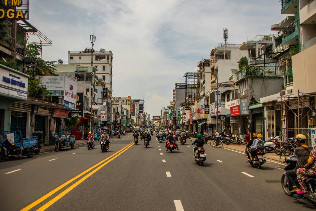 usy street with heavy motorbike traffic in Ho Chi Minh City, Vietnam