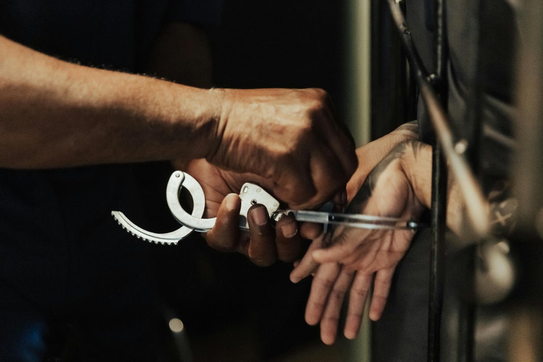 Police officer placing handcuffs on a suspect during an arrest