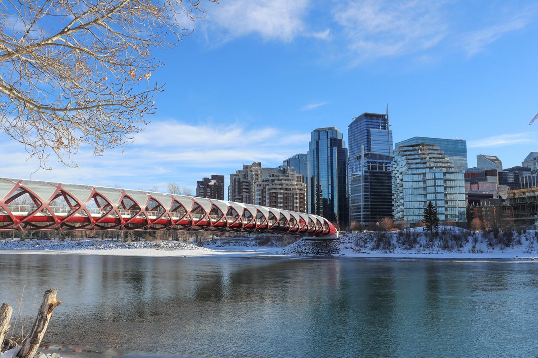 Calgary's Peace Bridge over the Bow River with the downtown skyline in winter