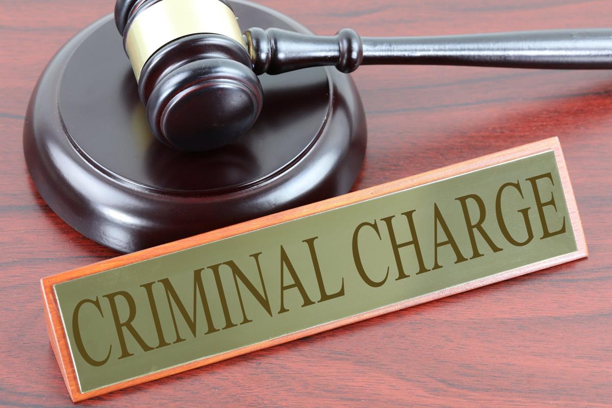 Las Vegas Little League Ex-President Faces Theft Charges Gavel and criminal charge sign representing Steve Rodriguez Prado's theft and forgery charges in the Little League case