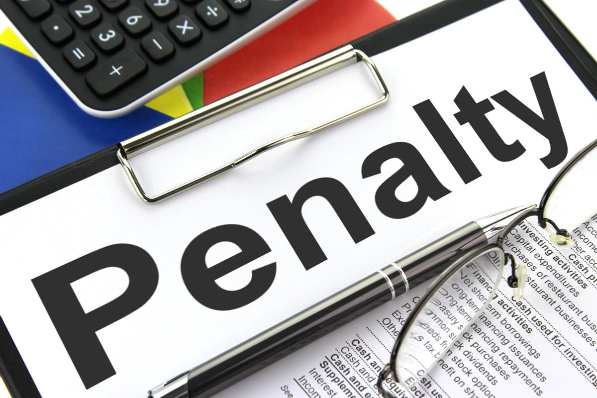 FINTRAC Fines New Brunswick, Nova Scotia Gaming Corps Close‑up of a clipboard with a paper labeled “Penalty,” metallic pen, eyeglasses, calculator, and colorful background symbolizing financial or legal fines