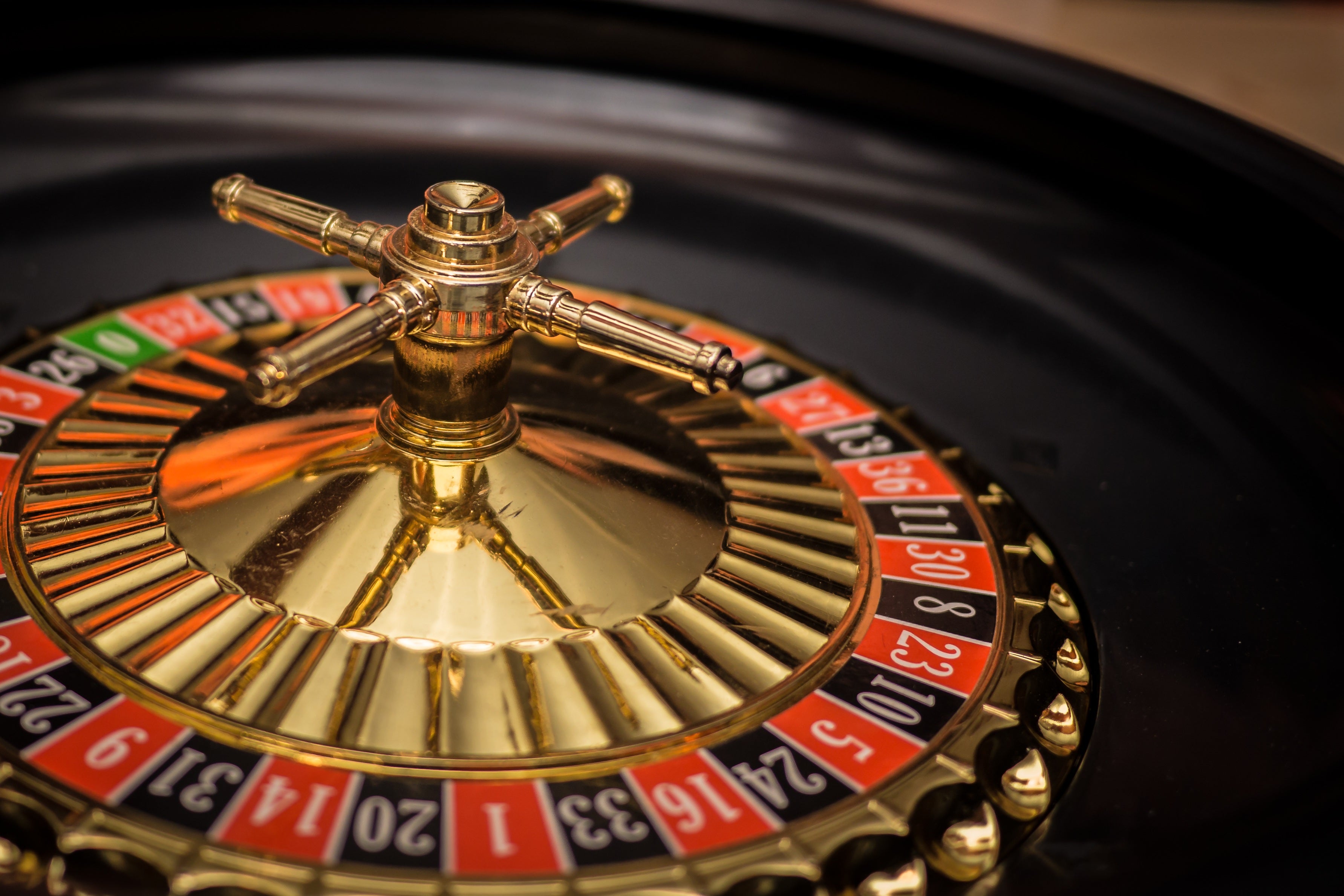 Close-up of a gold roulette wheel with red and black numbered pockets, illustrating Nevada's August gaming win