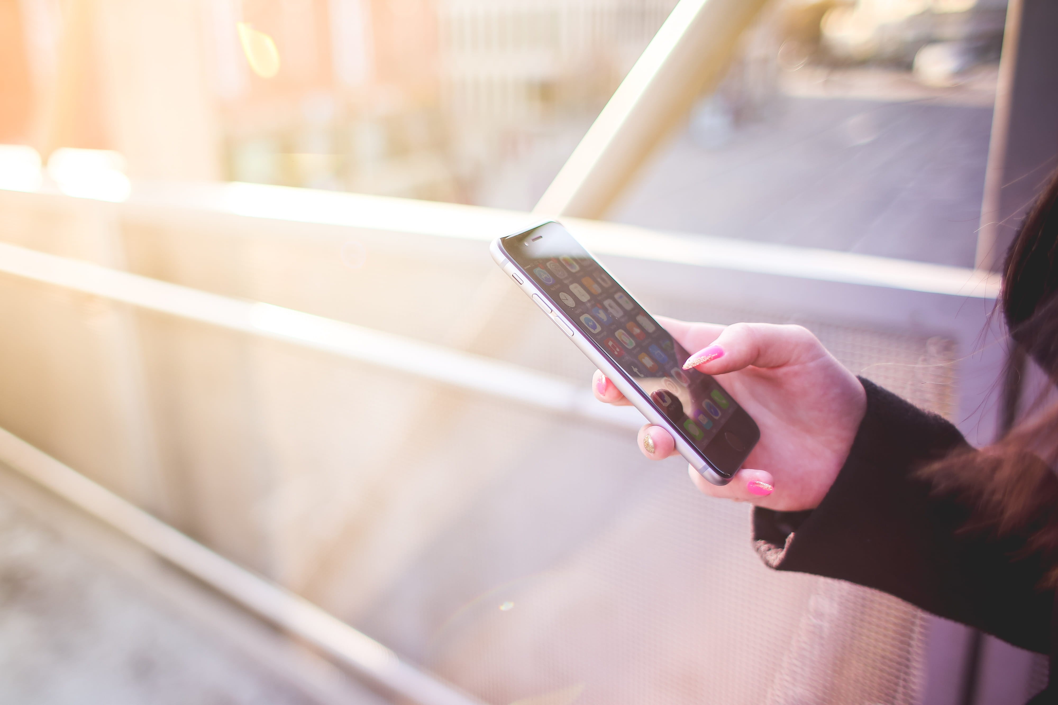 A person holds a smartphone in one hand, illustrating how players may use PAGCOR's planned app to verify licensed online gaming platforms.