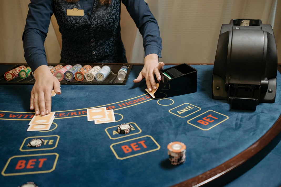 A Croupier Dealing Playing Cards