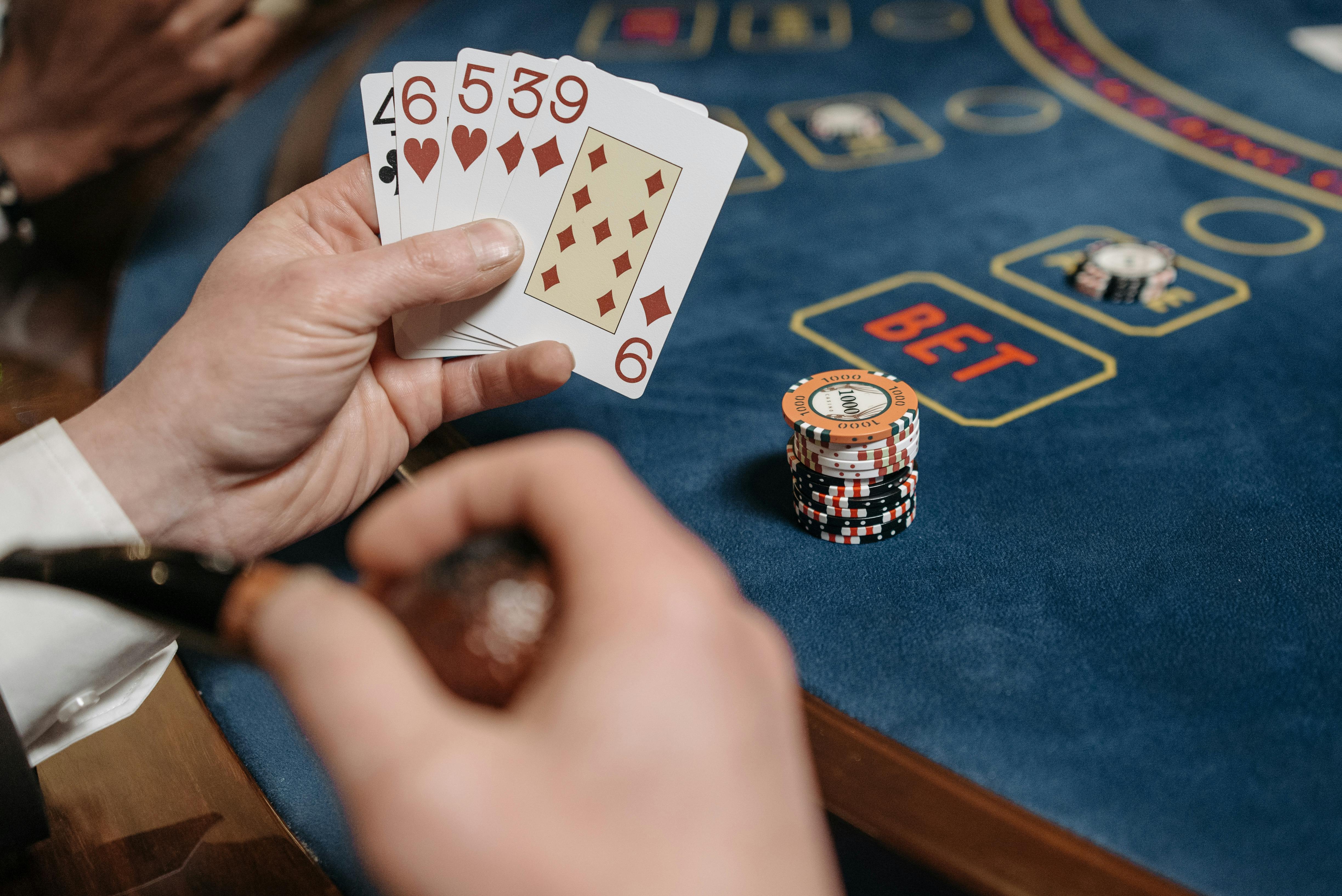 A Dealer Holding Up Playing Cards