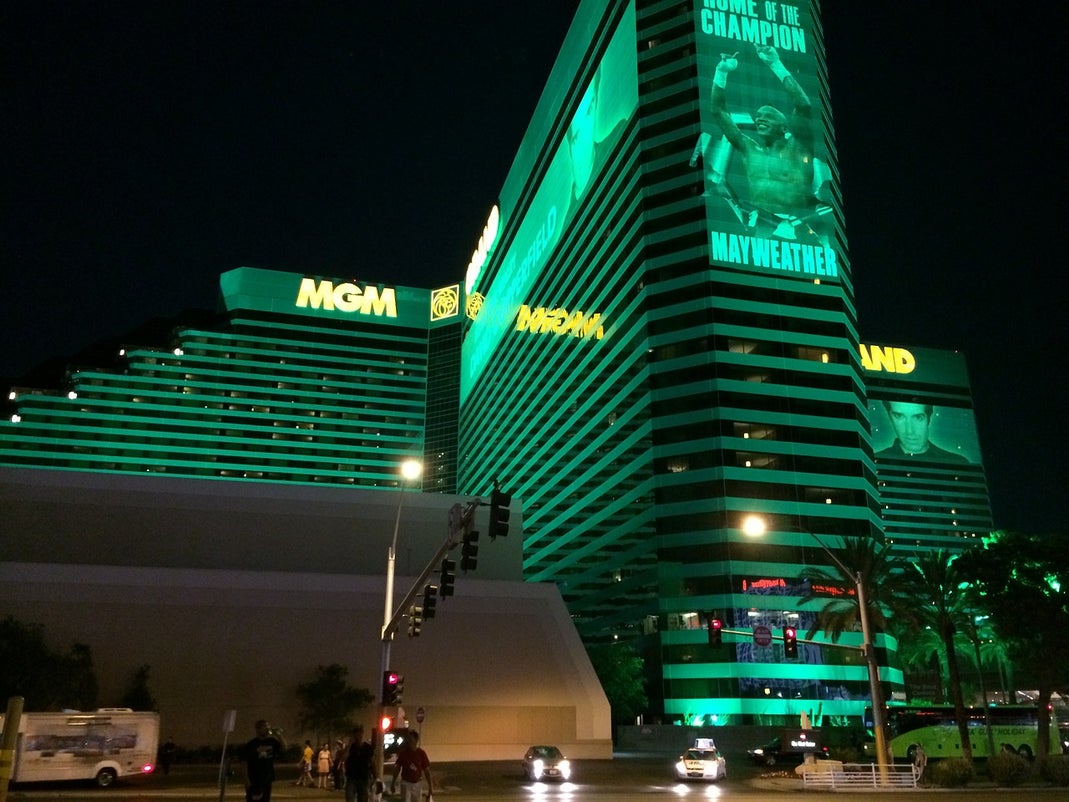 MGM Grand hotel and casino glowing green at night on the Las Vegas Strip