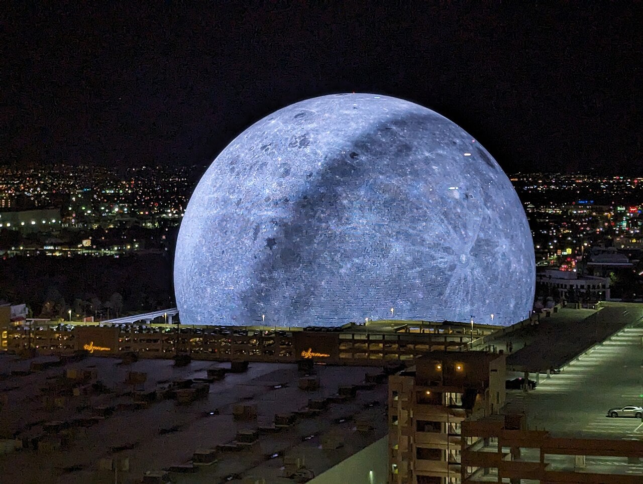 Sphere Las Vegas illuminated as the Moon at night in Las Vegas, viewed from a hotel overlooking the city skyline