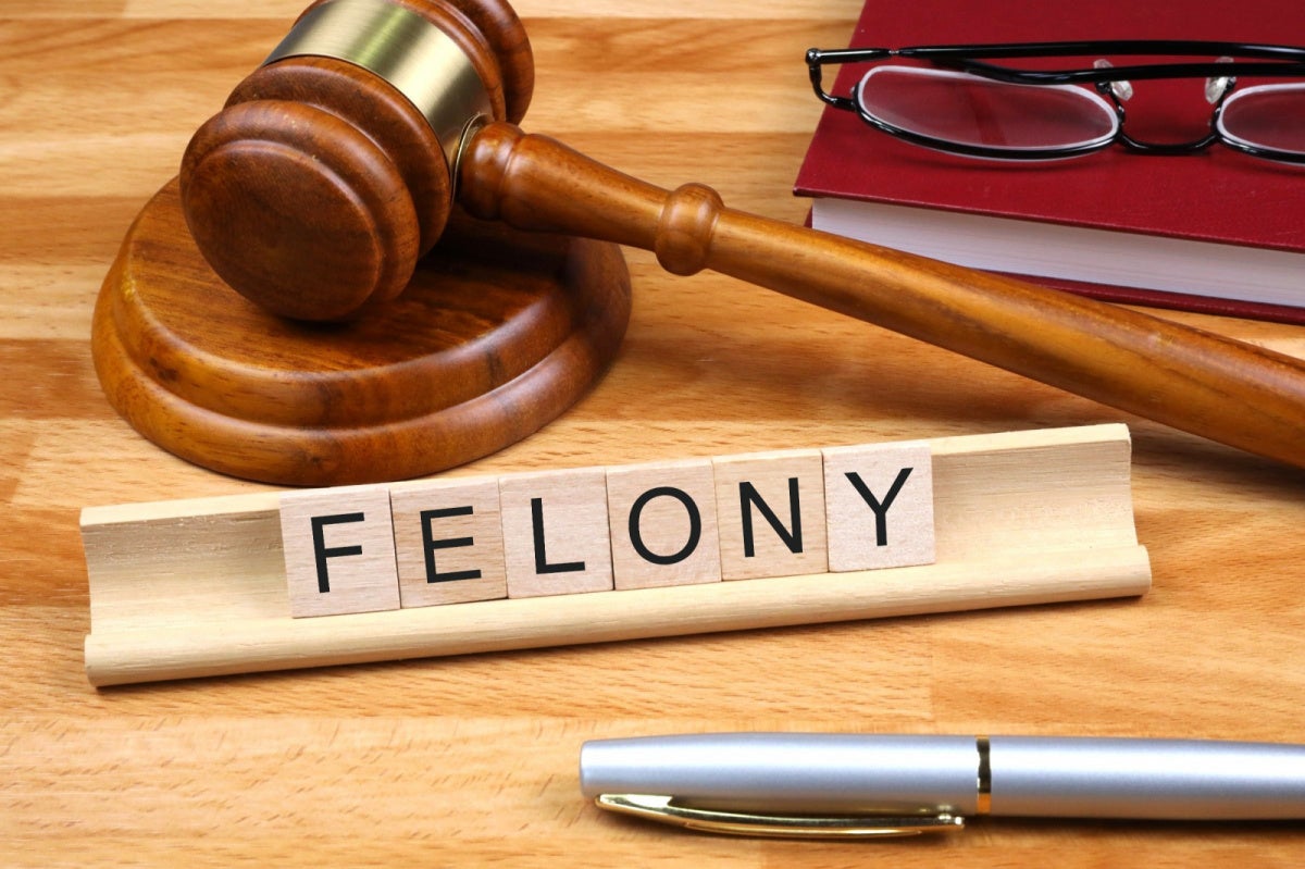 Ex-DraftKings Trader Charged in Fresno State Betting Scheme Wooden gavel and FELONY letter tiles representing felony charges in the DraftKings Fresno State betting scheme case