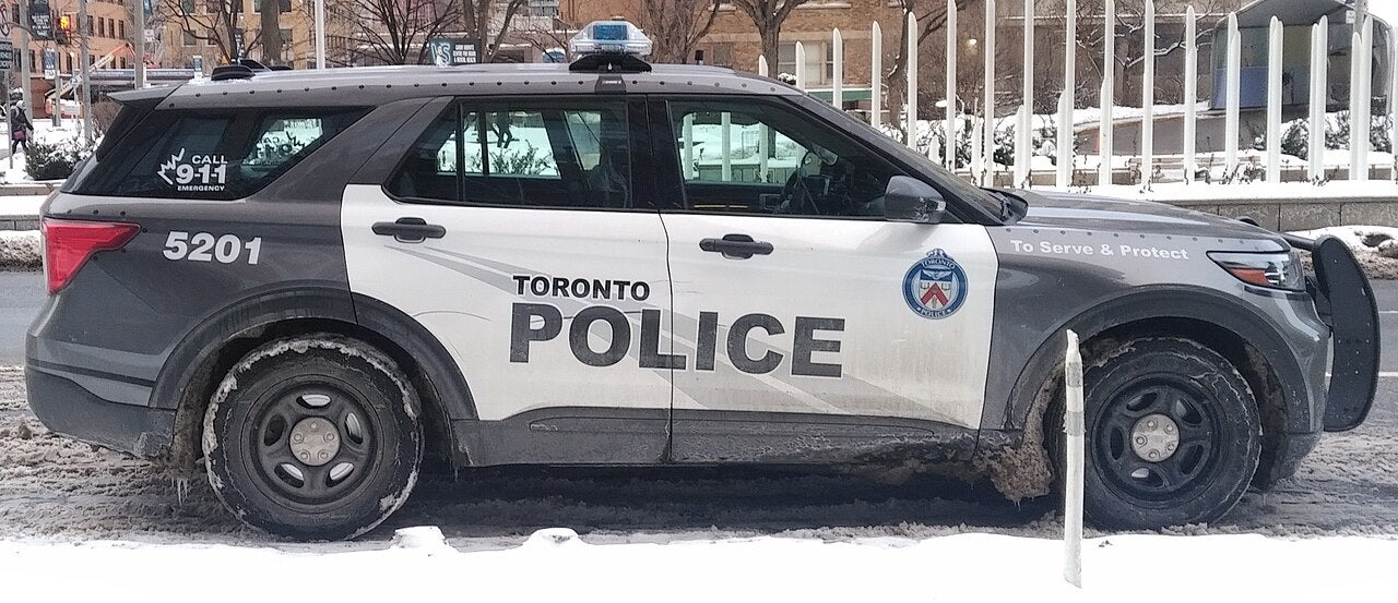 Toronto Police SUV with 2017 livery parked on a snowy street, marked “To Serve & Protect” and equipped with emergency lights
