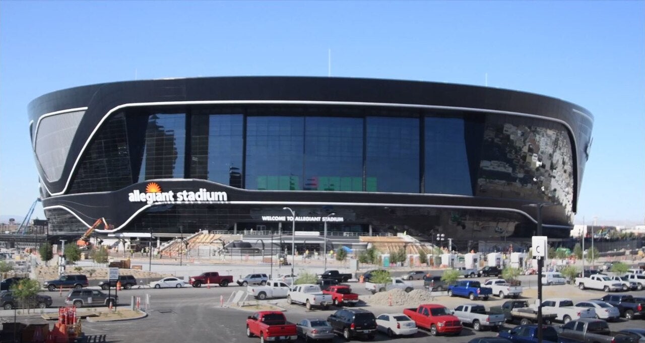 Exterior view of Allegiant Stadium in Las Vegas, Nevada, showing the modern black facade and surrounding area in June 2020