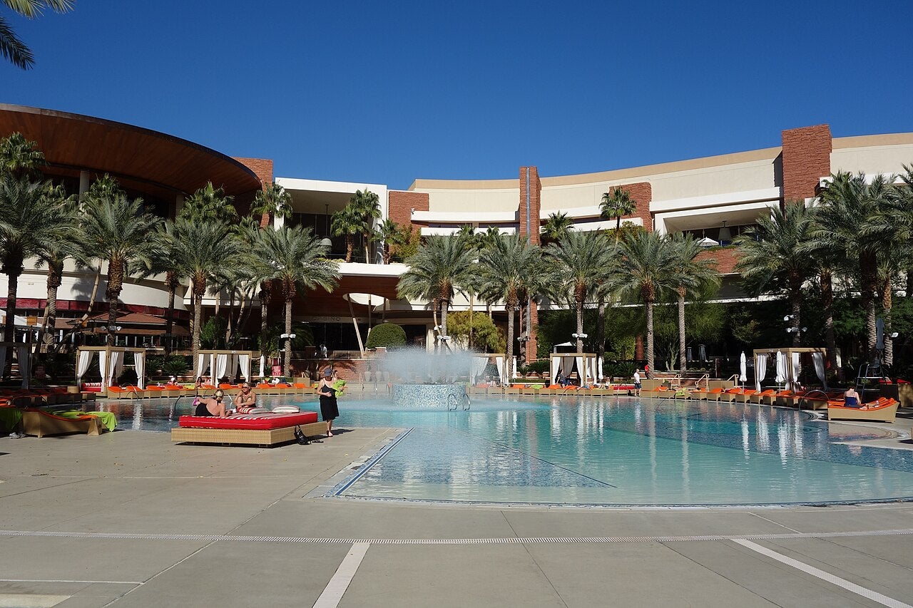 Swimming pool area at Red Rock Casino Resort with palm trees and lounge chairs in Las Vegas, Nevada