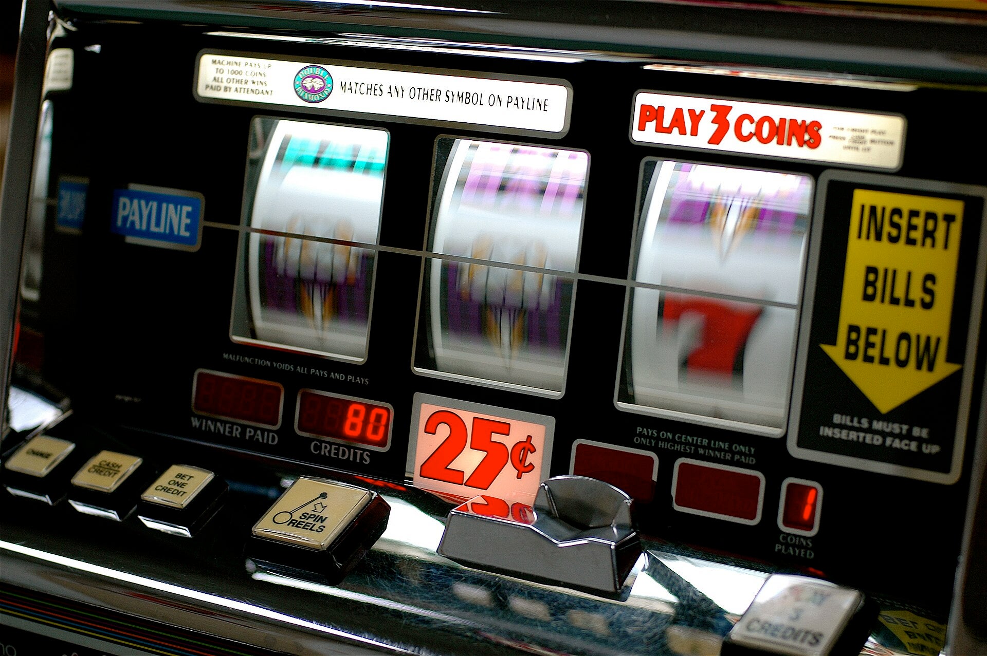 Harry Reid International Airport: $3.3M Jackpot Winner Close-up of a classic slot machine with spinning reels and a 25-cent play sign