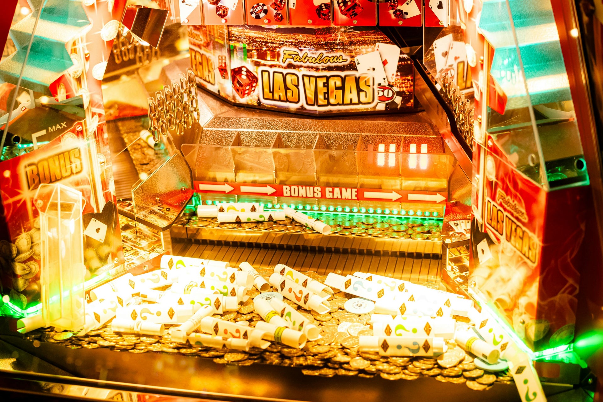 A lit-up Las Vegas-themed slot machine bonus game display with gold coins