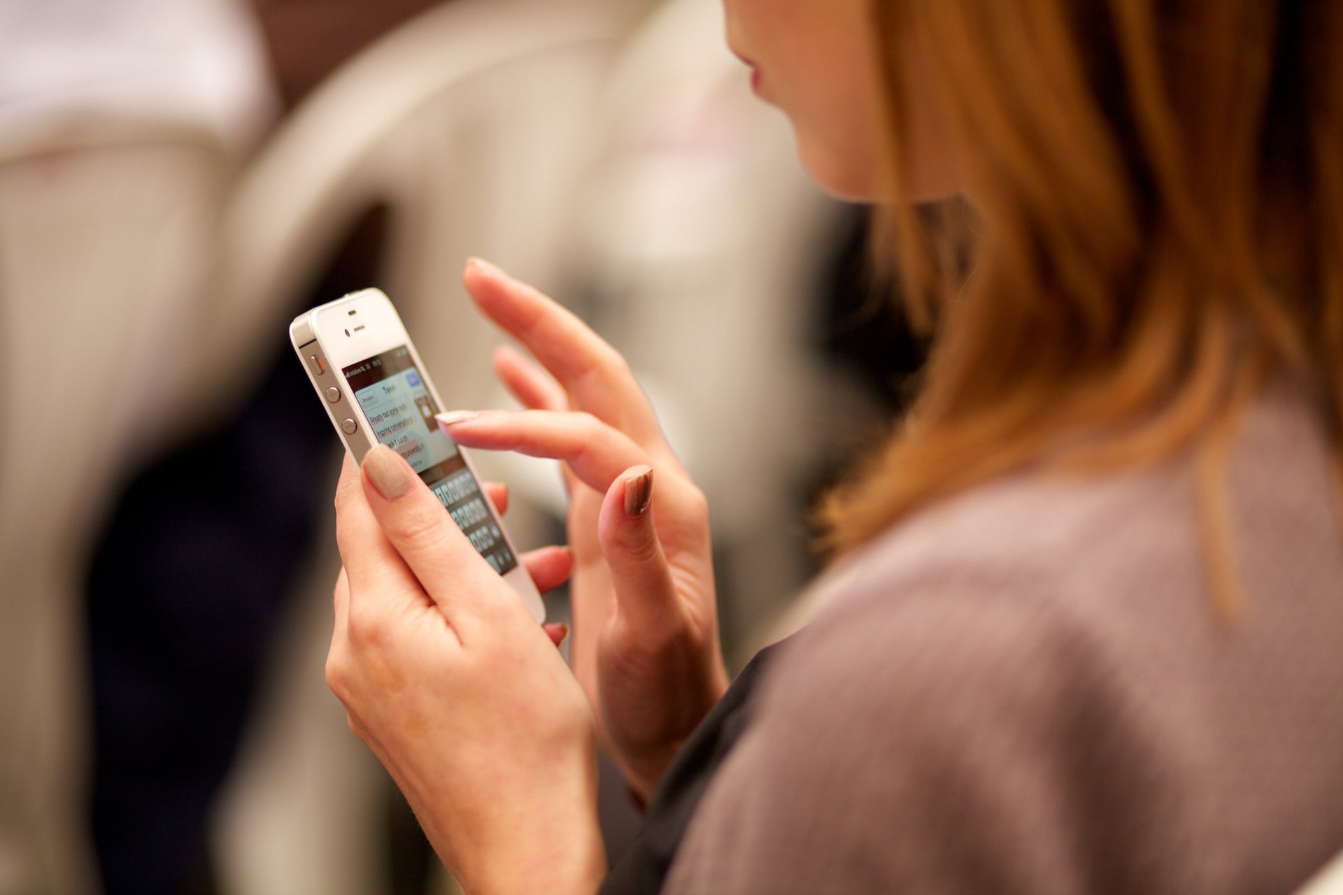 A woman looking at her smartphone screen